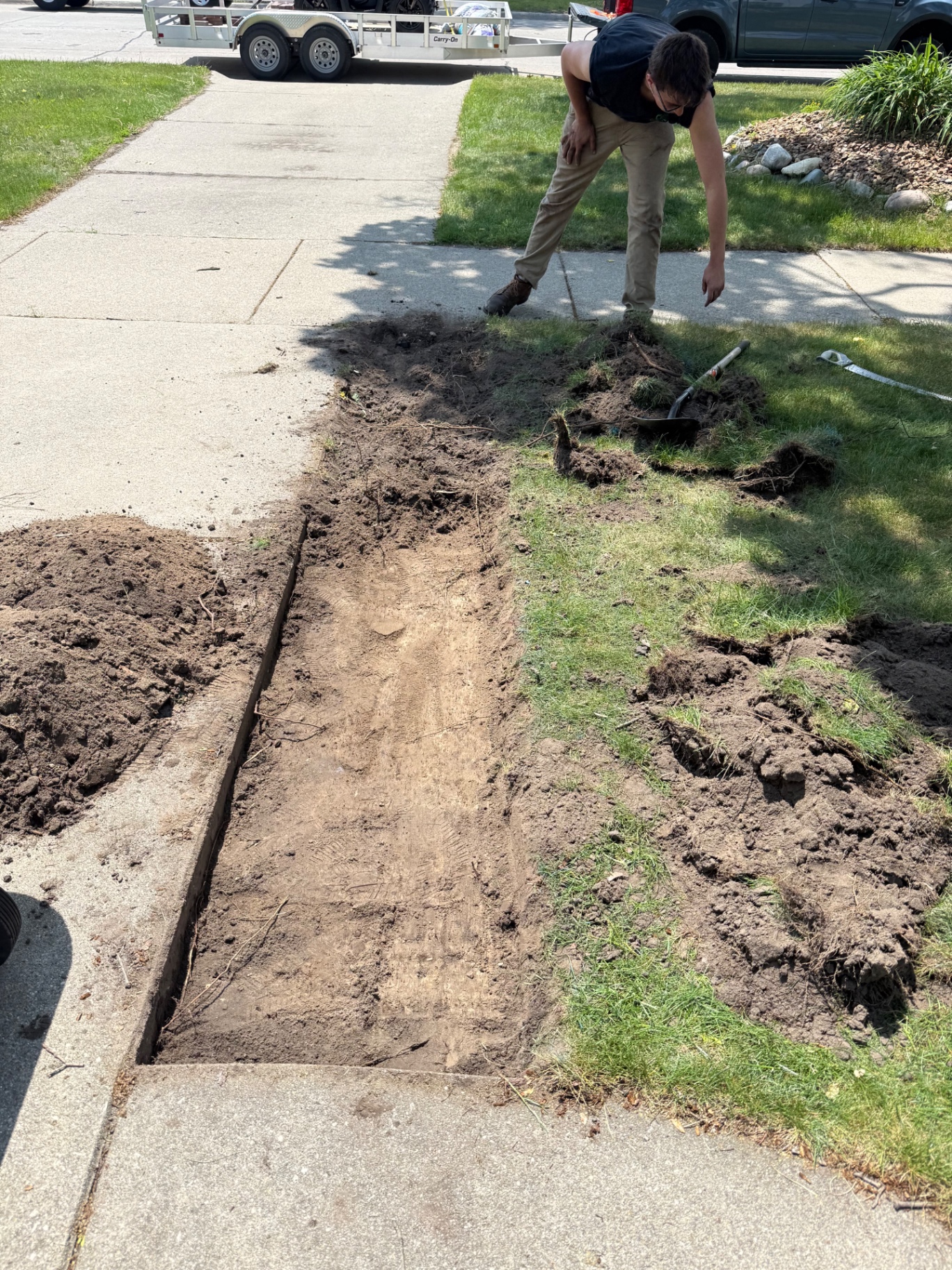 Crew prepping ground for a new paver walkway installation